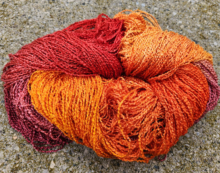 Rayon yarn in our Solei colorway of reds, oranges, and yellows