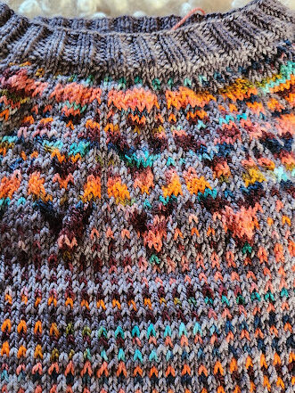 Closeup of a color work sweater knit by Keli 